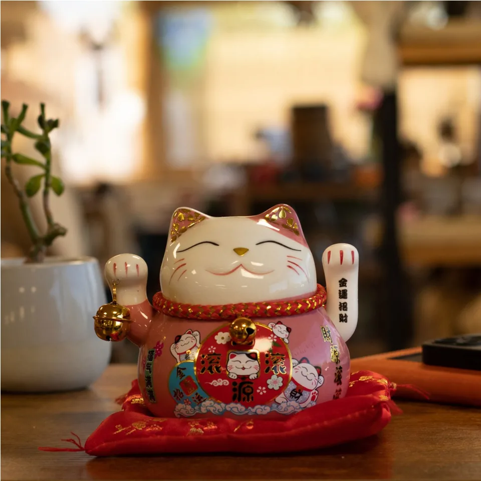 Chat en céramique à bras mobile sur coussin : rose sur coussin (piles non fournies)