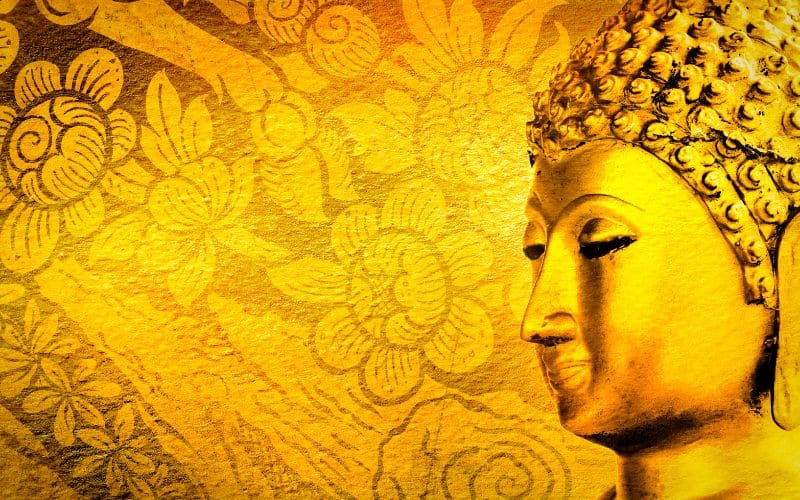 Tableau illuminé avec dessins floral et tête de Bouddha de profil.
